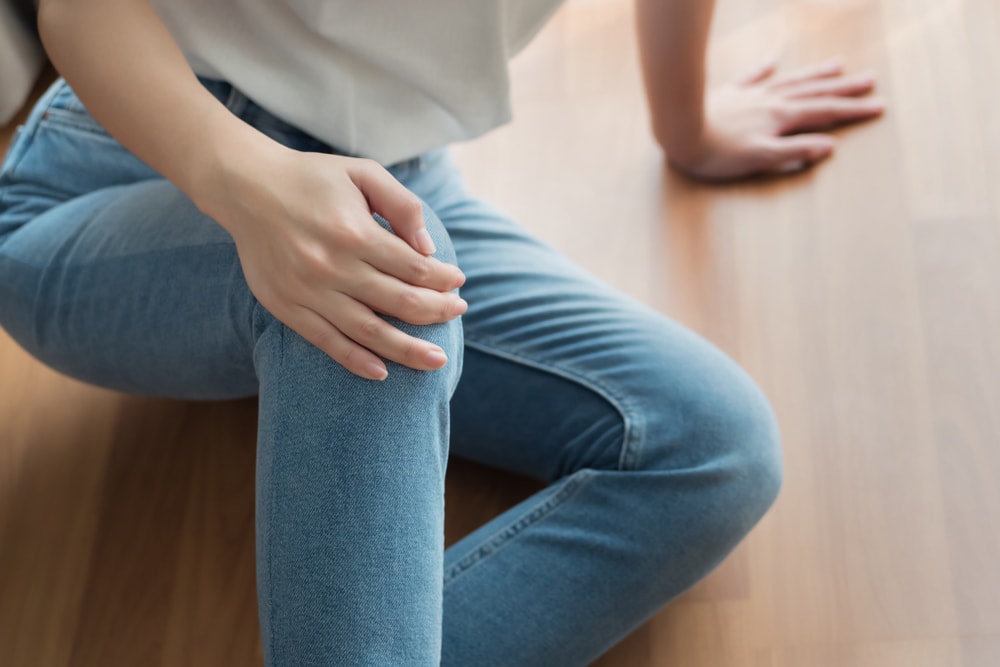 injured woman with broken knee or leg pain.