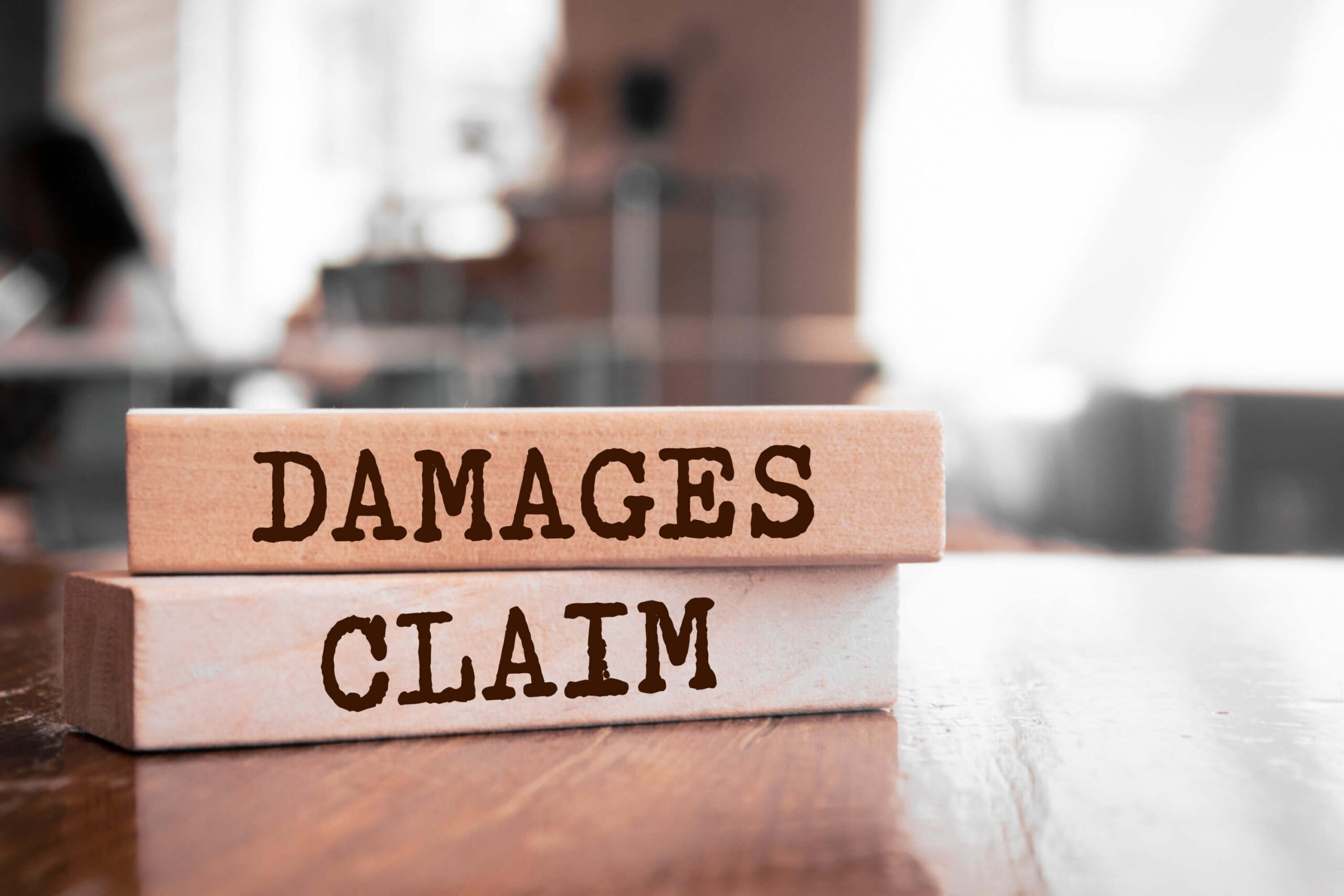 Wooden blocks with the words 'Damages and Claims'