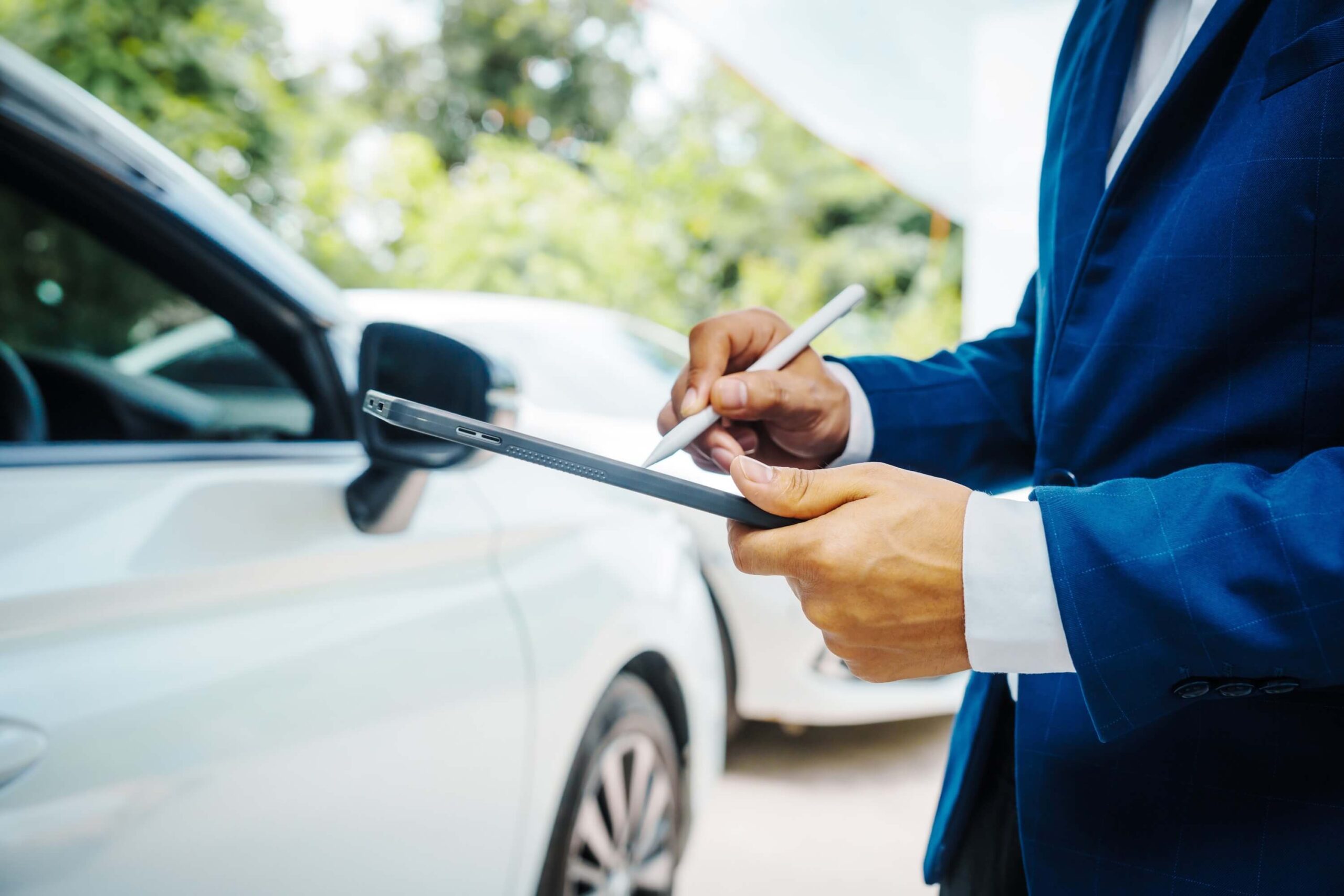 The auto insurance agent assesses the damage to the car